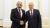 Russian President Vladimir Putin (R) and Armenian Prime Minister Nikol Pashinian meet in the Kremlin, Moscow, October 12, 2021.