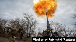 Українська військовослужбовець разом з іншими побратимами-артилеристами веде вогонь з САУ 2С7 «Піон» по позиціях російської армії, Херсонська область, 9 листопада 2022 року