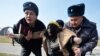 KYRGYZSTAN -- Kyrgyz police arrest a woman protesting against gender-based violence to mark International Women's Day in Bishkek, March 8, 2020.