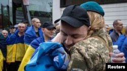 Former Ukrainian prisoners of war (POW) arrive after a prisoner swap with Russia, amid Russia's attack on Ukraine, in an undisclosed location in Ukraine, May 6, 2025.